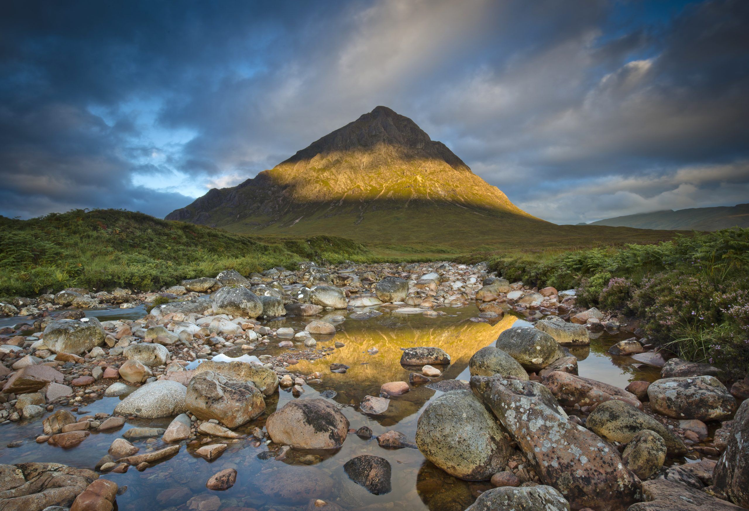Rocky landscape with a large conical mountain in the background.