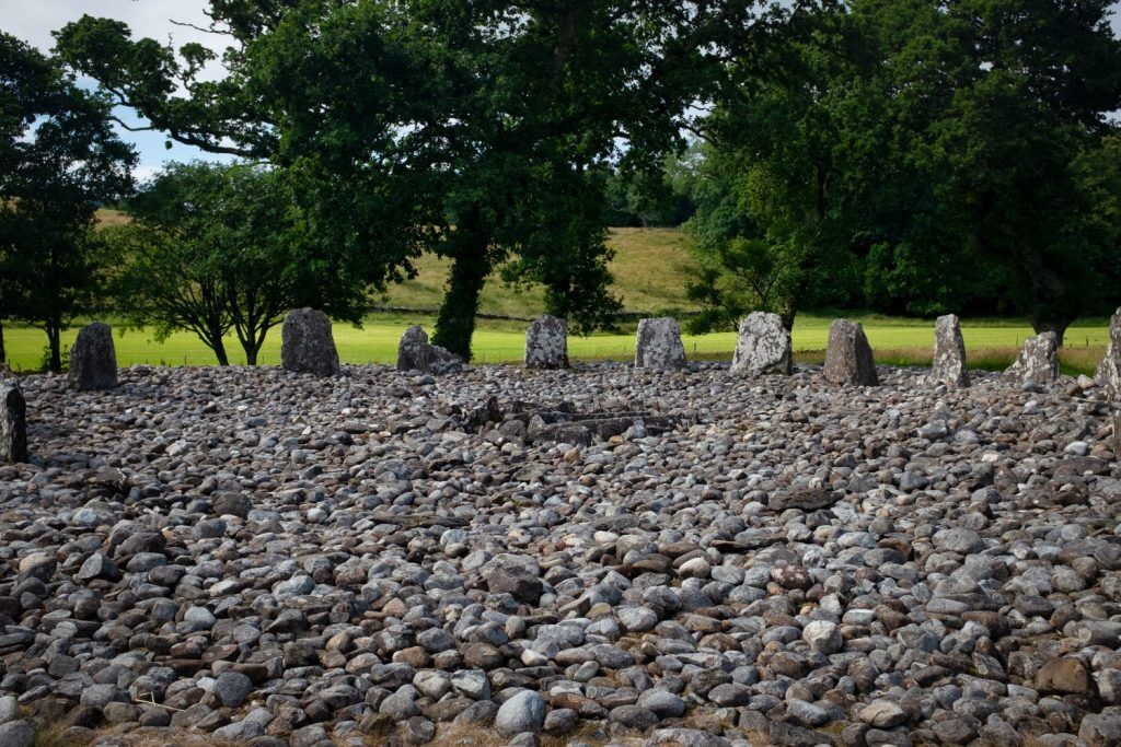 Stone ruins with standing stones in a wood.